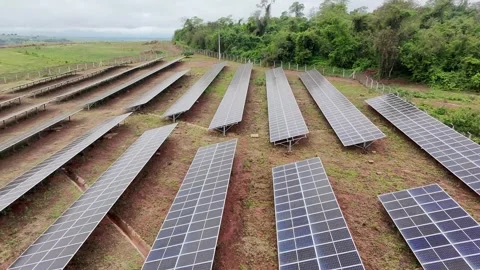 Low Drone Flight Over Solar Panels With Lateral Movement on Cloudy Day Stock Footage 321568738