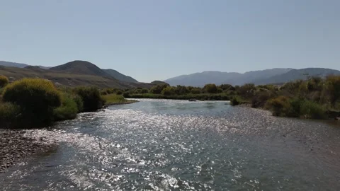 Low drone flight over a sparkling river, Kok-Moinok, Kyrgyzstan Video stock 347239842