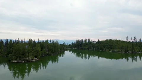 Low drone flight over Štrbské Pleso lake rising to mountains Stock Footage 314766880