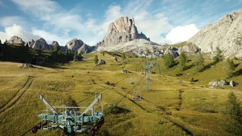 Low Drone Flight over Summer Field with Ski Lift near Monte Averau, Dolomites Video stock 316641338