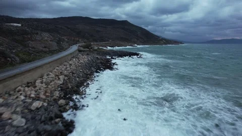 Low drone flight over surf and rocks on a stormy coast, Crete Stock Footage 346723823