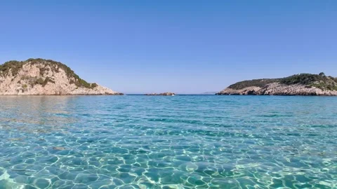 Low drone flight over turquoise water at Voidokilia Beach Stock Footage 335894957