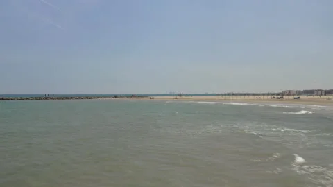 Low drone flight over waves rolling onto a white sandy beach 스톡 동영상 150339839