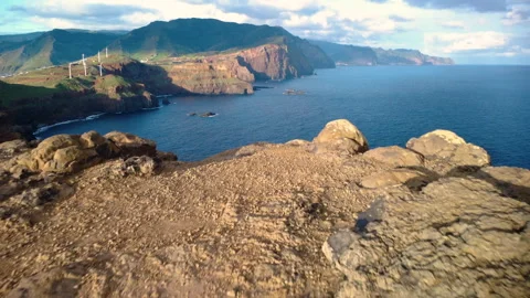 Low drone flight over yellow rocky cliffs of Ponta do Rosto, Madeira Vídeos de archivo 328594027