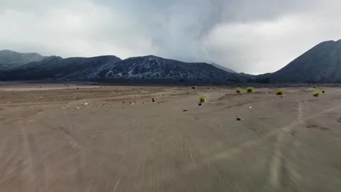 Low Drone Flight Rising Toward Smoking Volcano Crater in Indonesia Stock Footage 315117712