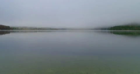 Low drone flying over misty Alpine lake in Slovenia Stock Footage 147486935