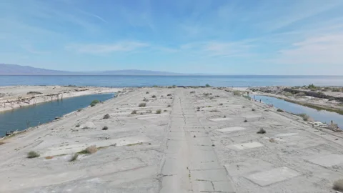 Low Drone Flyover of Abandoned Desert Shores Marina with Salton Sea Stock-Footage 332679447