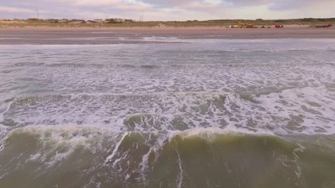 Low Drone Flyover Following Waves from Sea to Shore with Bird | FlyLens 4K Stockbeeldmateriaal 309455977