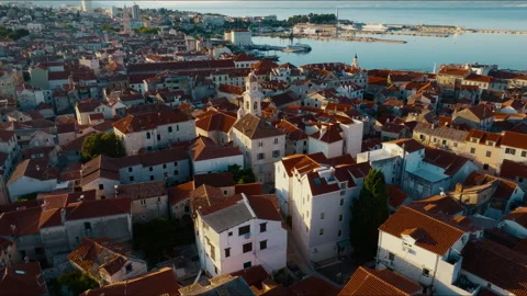 Low drone orbit around church over Split Old Town rooftops at sunrise, Croatia Stock Footage 341674015