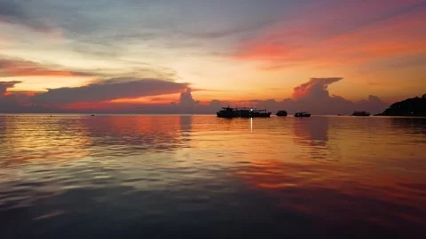 Low Drone Orbit Over Water with Colorful Sunset Koh Tao Stockbeeldmateriaal 331867302
