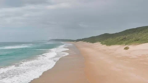 Low drone over beach, waves crashing 2 Stock Footage 304266299