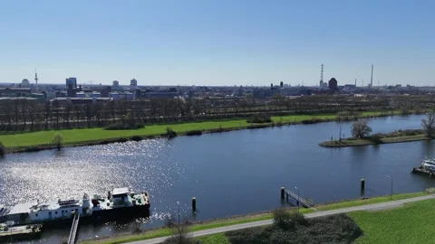 Low drone over canal facing Duisburg skyline Stock Footage 331896836