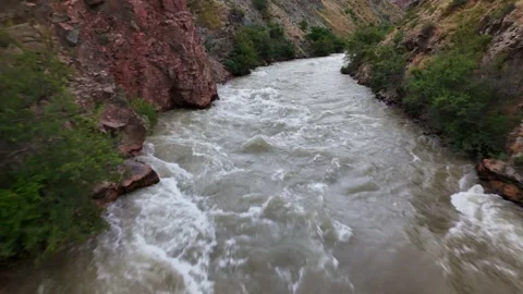 Low drone over churning whitewater rapids in red rock canyon of Boom Gorge, Stock Footage 341871432