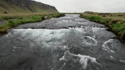 Low drone pull back over rushing Fossalar river rapids close up, Iceland Stock Footage 346551962