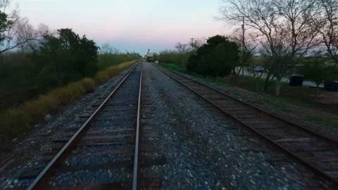 Low Drone Shot Following Parallel Railroad Tracks in Small Texas Town Late A Stock-Footage 308189750