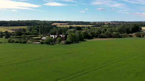 Low drone shot over grass blowing in the wind approaching a farmhouse. 4k Stock Footage 147216656