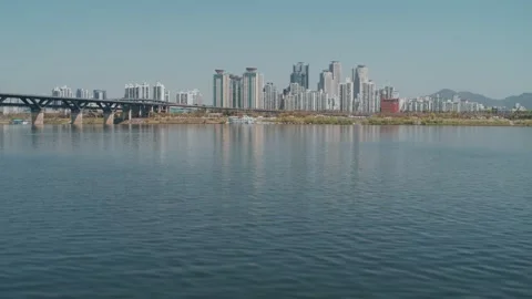 Low drone shot over Han river rising up to city. Seoul South Korea Stock Footage 260784585