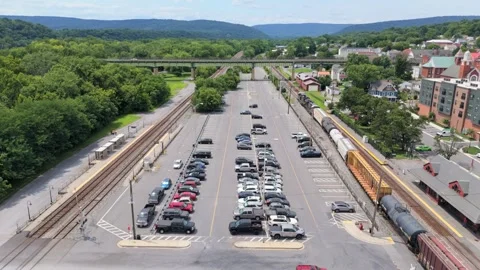 Low Drone Tracking Shot of Train with Mountain Landscape Stock Footage 342829621