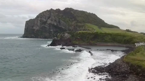 Low Drone View of East Side of Seongsan Sunrise Peak (성산일출봉), Jeju Stock Footage 143881472