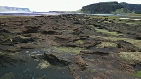 Low drone view over rugged volcanic lava formations Iceland 4K Stock-Footage 343869517