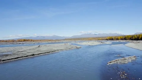 Low elevation aerial view of Knik River in Alaska on sunny autumn day Stockbeeldmateriaal 228017431