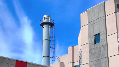 Low emission exhaust stack integrated into a contemporary concrete facility Stock Footage 332611603