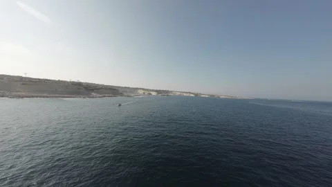 Low exciting FPV drone flight over the sea with a yacht RAW video Stock Footage 248690650