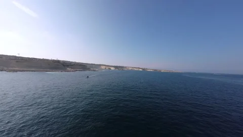 Low exciting FPV drone flight over the sea with a yacht Stock Footage 248690812