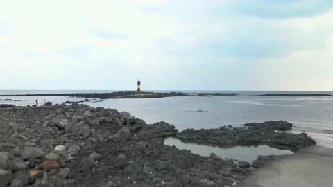 Low Fast Flight to a Lighthouse, Udo-biyangdo, Jeju Volcanic Island Stock Footage 146067137