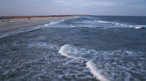 Low fast flight over beach and surf, heading for Beach Haven, New Jersey. Shot Stock Footage 59220025