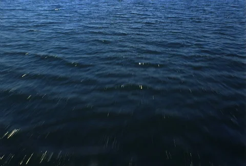 Low, fast flight over ocean water Stock Footage 86884088