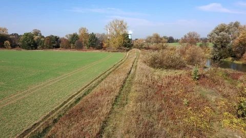 Low flight above causeway, on the left side arable fields on the right Stock Footage 118665973