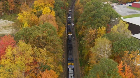 Low flight above train traveling through Massachusetts woods Stock Footage 59520452