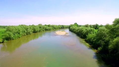 Low flight. Aerial View 4k. Flying over the beautiful River. Aerial camera shot Stock Footage 77053110