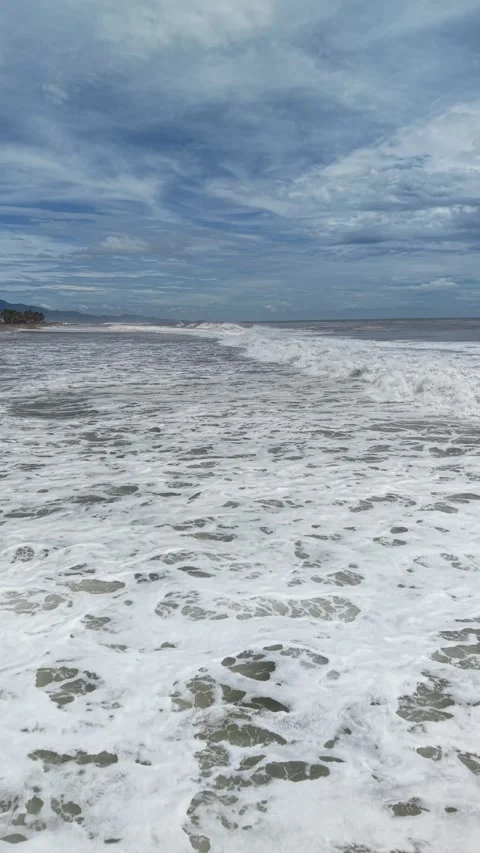 Low flight along a storm beach, vertical drone, Pacific near Acapulco Stock Footage 348301207