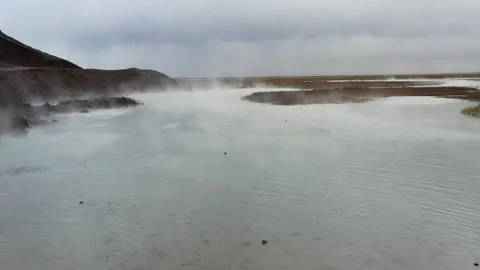 Low flight with drone over the hot pond that evaporates in winter. Stock Footage 246673618