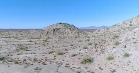 Low flight over barren feature in the desert aerial drone shot Stock Footage 147241982