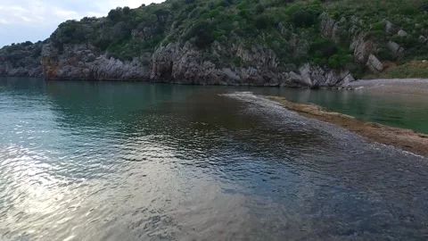 Low flight over the beach and beach-rock near Ancient Asine, Greece, and the Stock Footage 146030437