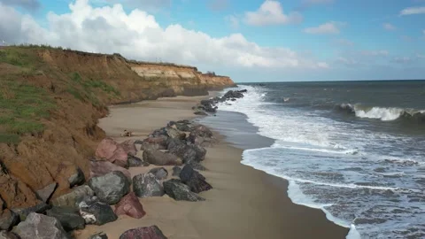 Low flight over beach boulders slow motion Stock Footage 220312266