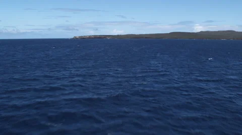 Low flight over blue Pacific water toward the island of Molokai Stock Footage 59521518