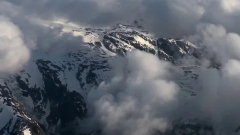 Low flight over clouds and mountains. Fly Video stock 69829608