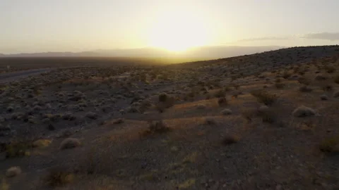 A low flight over the desert into the setting sun. Stock Footage 155707645