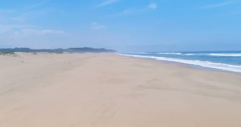 Low flight over deserted beach on the Indian Ocean aerial 4K Stock Footage 87573945