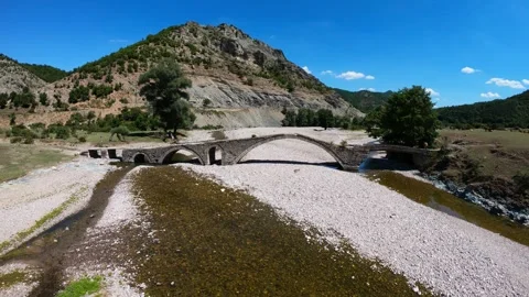 Low Flight Over Dry Riverbed and Nenkovo Bridge Stock Footage 321560813