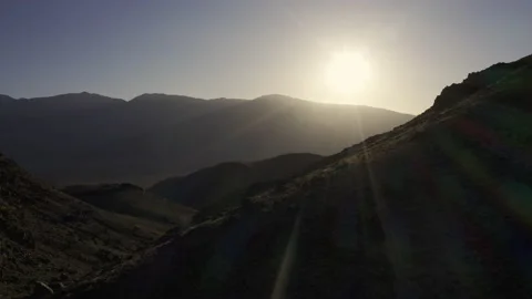 A low flight over a mountain ridge at sunrise. Stock Footage 155578112