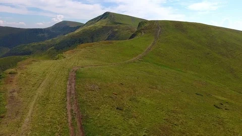 Low flight over the mountain road on the ridge Stock Footage 83982646