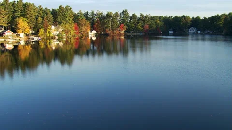 Low flight over New England lakeshore in autumn Stock Footage 59520001