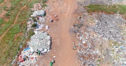 Low flight over piles of trash in rural dump site aerial 4K Video stock 85643687