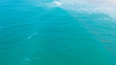 Low Flight Over the Sandy Beach and Waves Stock Footage 105198396