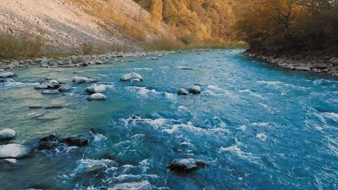 A low flight over a small waterfall and a mountain river, and crystal turquoise Video stock 92144545